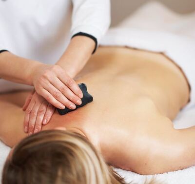 patient getting gua sha on their back for pain relief and relaxation