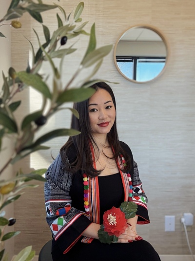 Hmong acupuncturist sitting in her acupuncture treatment room
